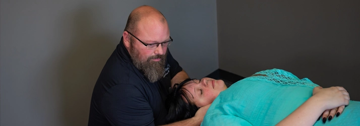 Chiropractor Broken Arrow OK Shannon Grimes Adjusting Patients Neck