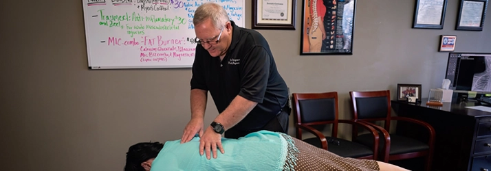 Chiropractor Broken Arrow OK Timothy Wagner Adjusting Patients Back