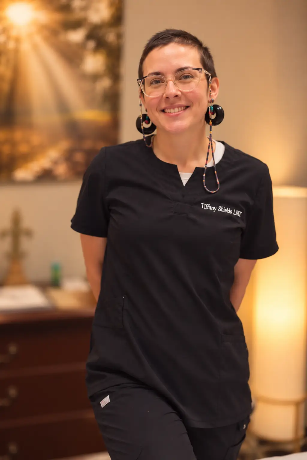 staff member in black uniform and transparent sun glasses smiling